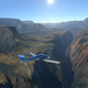 a plane flying over the grand canyon in microsoft flight sim